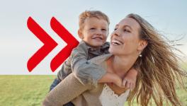 Mother and a child on big green field