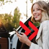 Woman getting out of the car while holding her phone