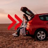 Couple sitting in the trunk of a car