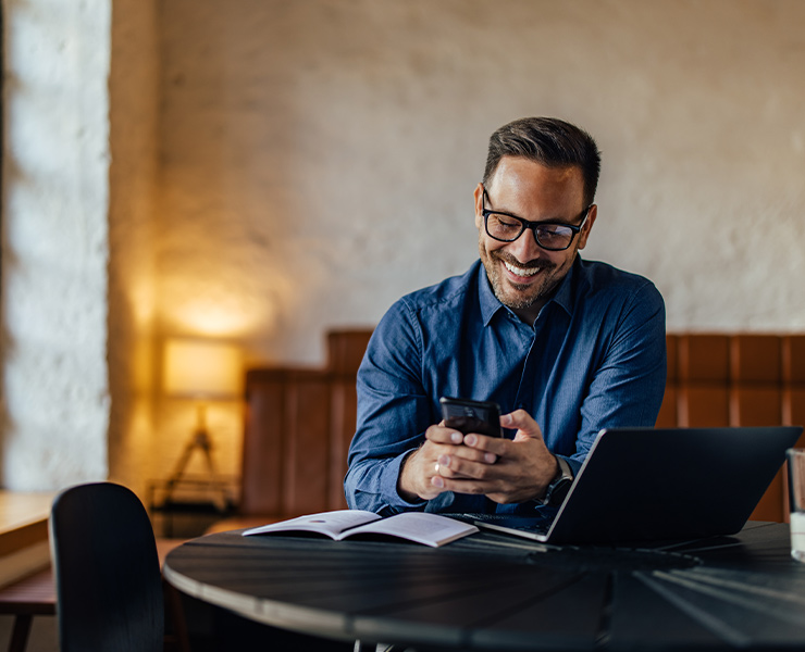 Man sitting at the table and holding on telephone