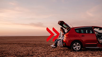 Couple sitting in the trunk of a car