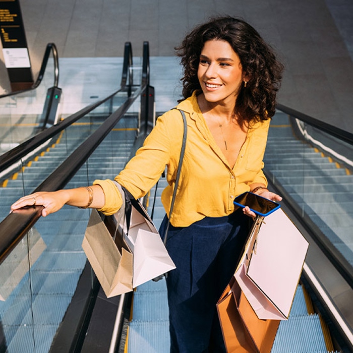 Woman on escalator after shopping